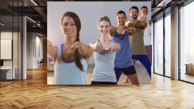 Group of fitness team performing stretching exercise Wall mural