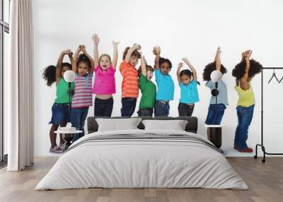 Group of kids standing in a line with raised arms Wall mural