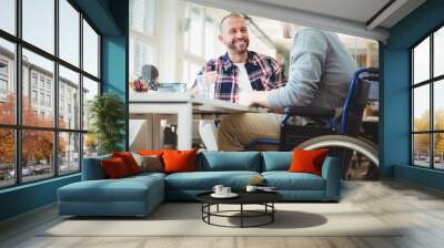 Handicap businessman sitting with colleague in office Wall mural