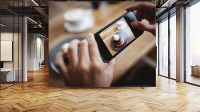 hands of woman taking a photo of sweet food from mobile phone Wall mural