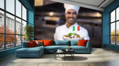 Handsome chef presenting meal with italian flag Wall mural