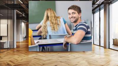 Handsome male student in class Wall mural