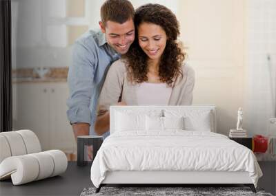 Handsome man cooking with his girlfriend Wall mural