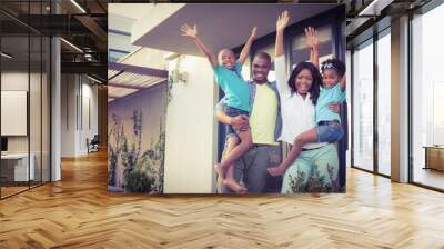 Happy afro-american family standing in the garden  Wall mural