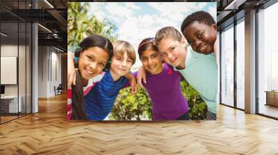 happy children forming huddle at park Wall mural