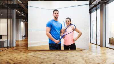 Happy couple after a squash game Wall mural