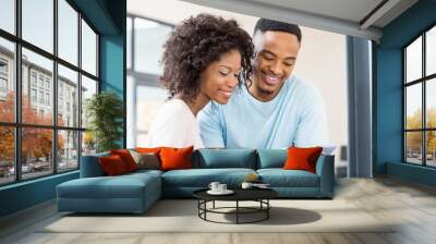 Happy couple using digital tablet Wall mural