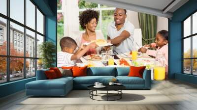 Happy family eating together Wall mural