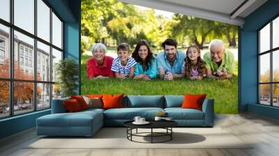 Happy family enjoying in park Wall mural