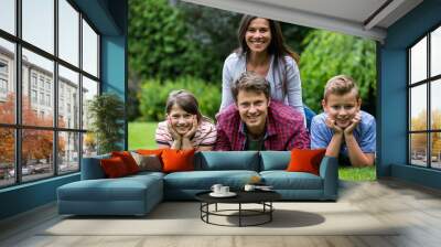 Happy family smiling in park Wall mural