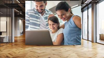 Happy family using laptop in the living room Wall mural