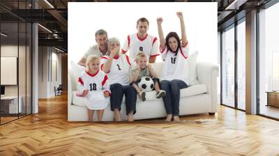 happy family watching a football match in television Wall mural