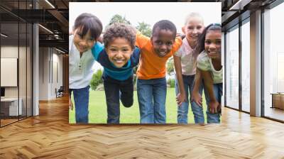 Happy friends playing in the park Wall mural