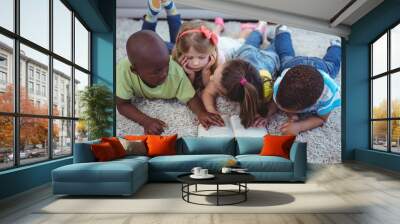 Happy kids reading a book together Wall mural