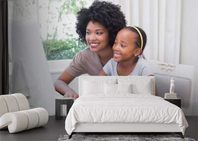 Happy mother and daughter using the computer Wall mural