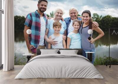 Happy multi-generation family standing near a river Wall mural