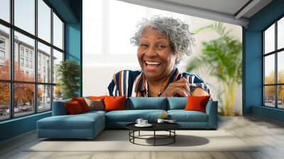 Happy senior african american woman with plaster on arm looking at camera after vaccination Wall mural