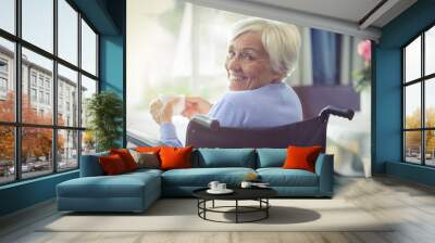 happy senior woman on wheelchair holding a cup of tea Wall mural