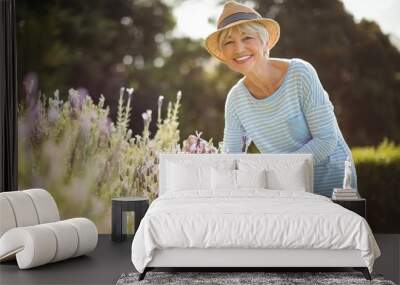 happy senior woman standing in backyard Wall mural