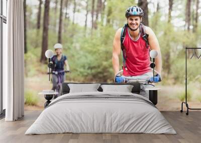 Happy young biker couple looking at camera Wall mural