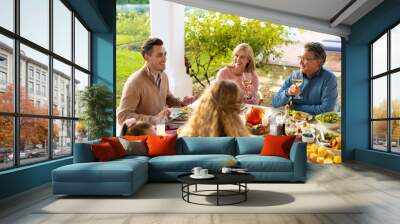 Image of multi generation caucasian family eating outdoor dinner Wall mural