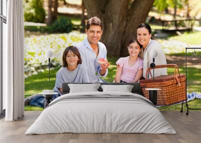 Joyful family picnicking in the park Wall mural