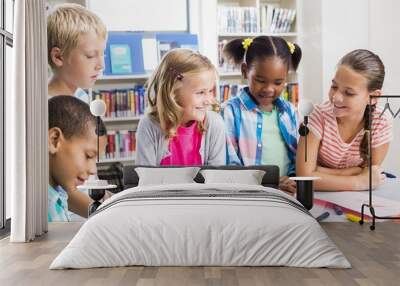 Kids interacting with each other in library Wall mural