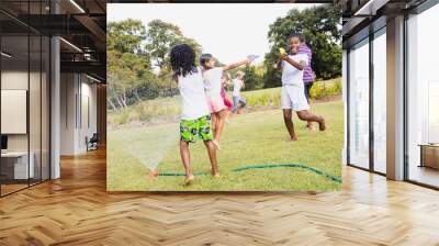 Kids playing together during a sunny day Wall mural