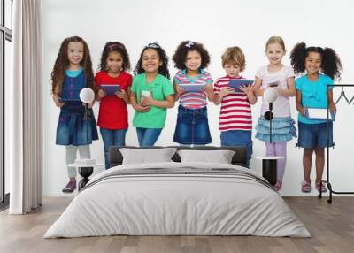 Kids standing together holding tablets and phones Wall mural