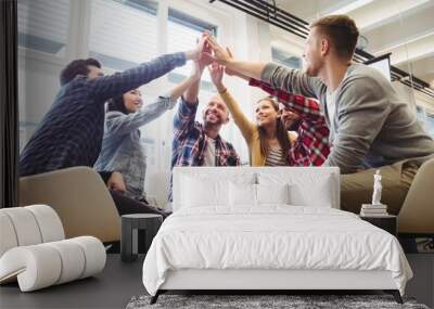 Low angle view of creative business people giving high-five Wall mural