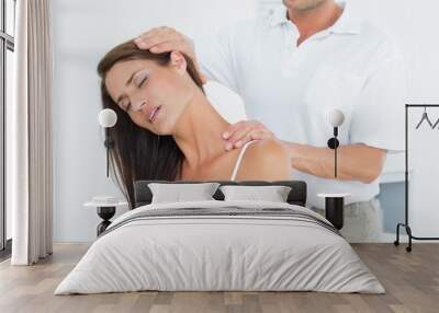 Male chiropractor doing neck adjustment Wall mural