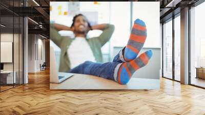 male graphic designer relaxing with feet up at desk Wall mural