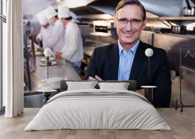 Male restaurant manager standing with arms crossed Wall mural