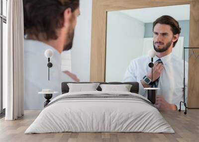 Man getting dressed in bedroom while looking at mirror Wall mural