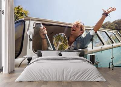 Man looking out of camper van window Wall mural