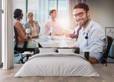 Man using laptop while coworker interacting in the background Wall mural