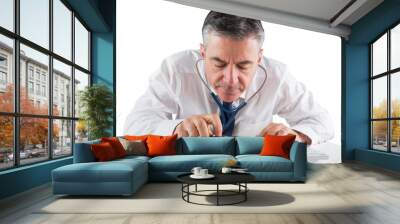 Mature businessman running diagnostics with stethoscope Wall mural