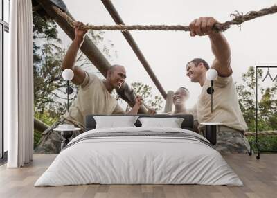 Military soldiers interacting during obstacle training Wall mural