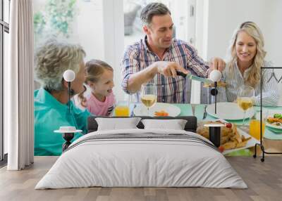 Multi- generation family having meal on dinning table Wall mural