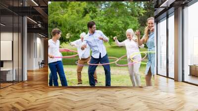 Multi-generation family playing with hula hoop Wall mural