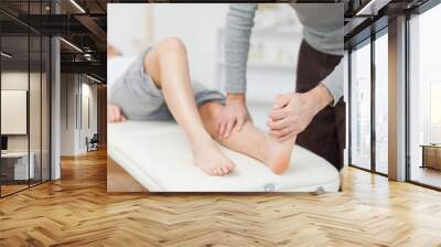 physiotherapist stretching a barefoot Wall mural