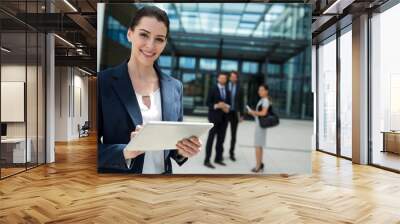 portrait of a businesswoman holding digital tablet Wall mural