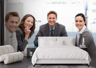 Portrait of a positive team sitting at a table Wall mural