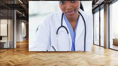 Portrait of a young female doctor writing a prescription Wall mural