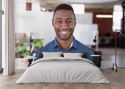 Portrait of african american businessman standing in office smiling to camera Wall mural