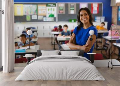 Portrait of african american female teacher smiling in the class at school Wall mural