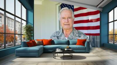 Portrait of caucasian army soldier wearing camouflage clothing standing against flag of america Wall mural