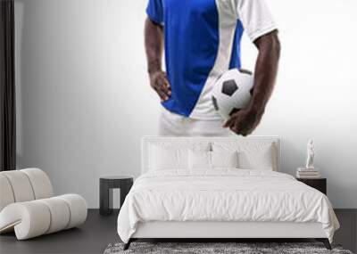 Portrait of confident male african american soccer player holding ball on white background Wall mural