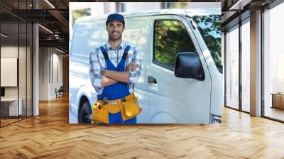 Portrait of happy carpenter with arms crossed  Wall mural