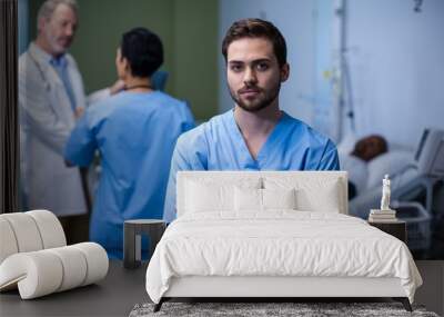 Portrait of male nurse standing in ward Wall mural